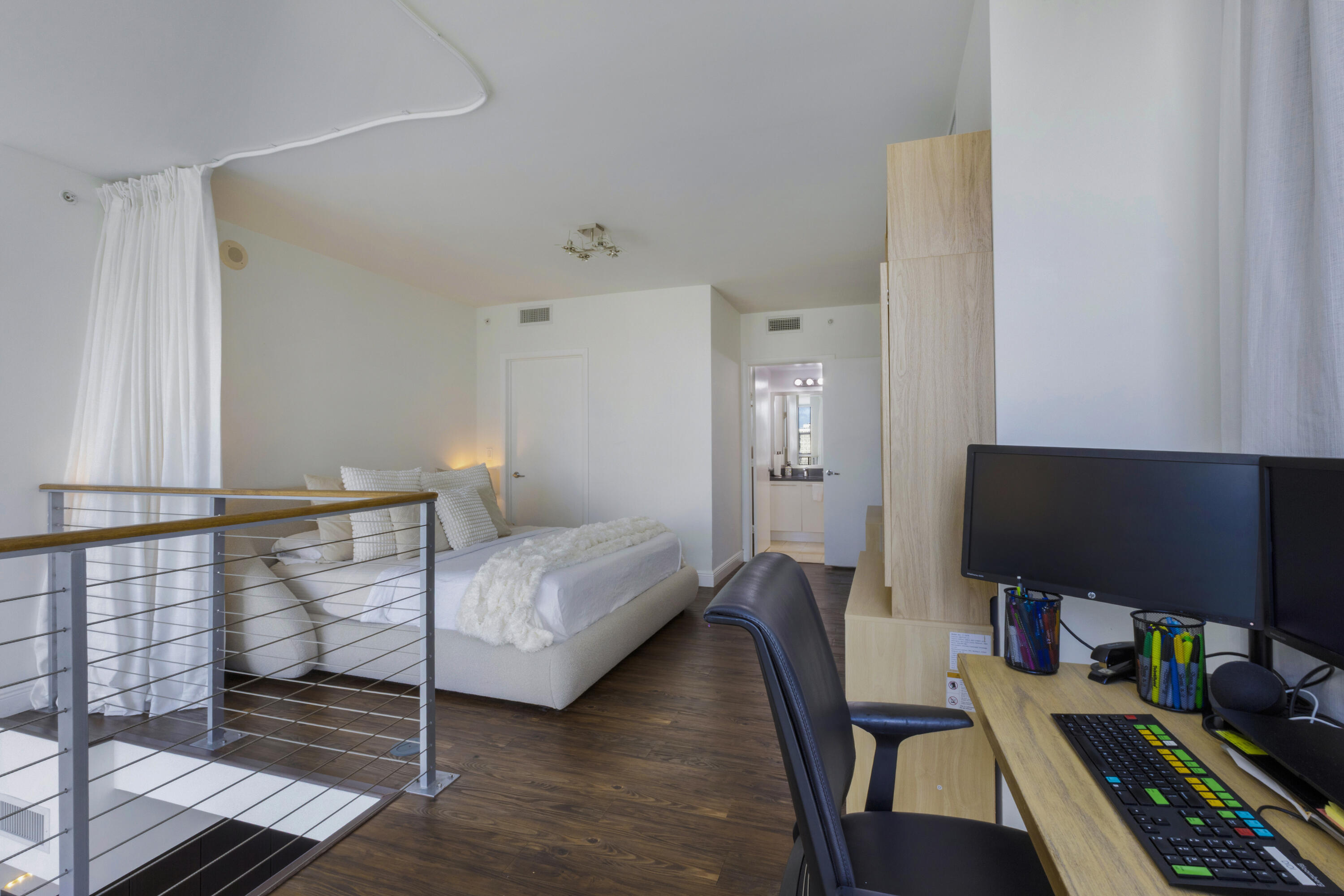 90 Southwest 3rd Street, Unit TH700A Miami, FL 33130 - Photo 7 of 32 a bedroom with furniture and a wooden floor