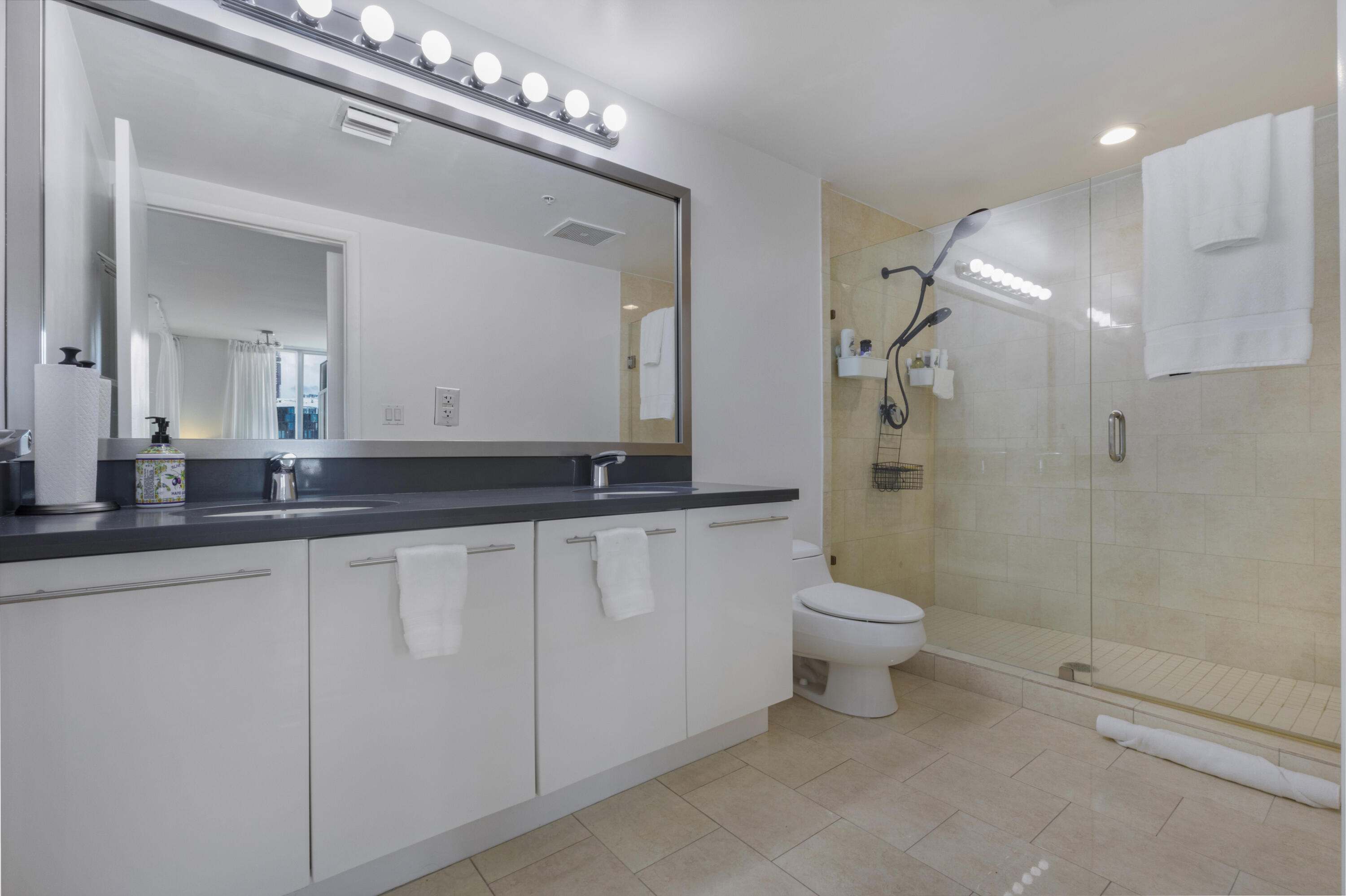 90 Southwest 3rd Street, Unit TH700A Miami, FL 33130 - Photo 8 of 32 a bathroom with a double vanity sink and a toilet