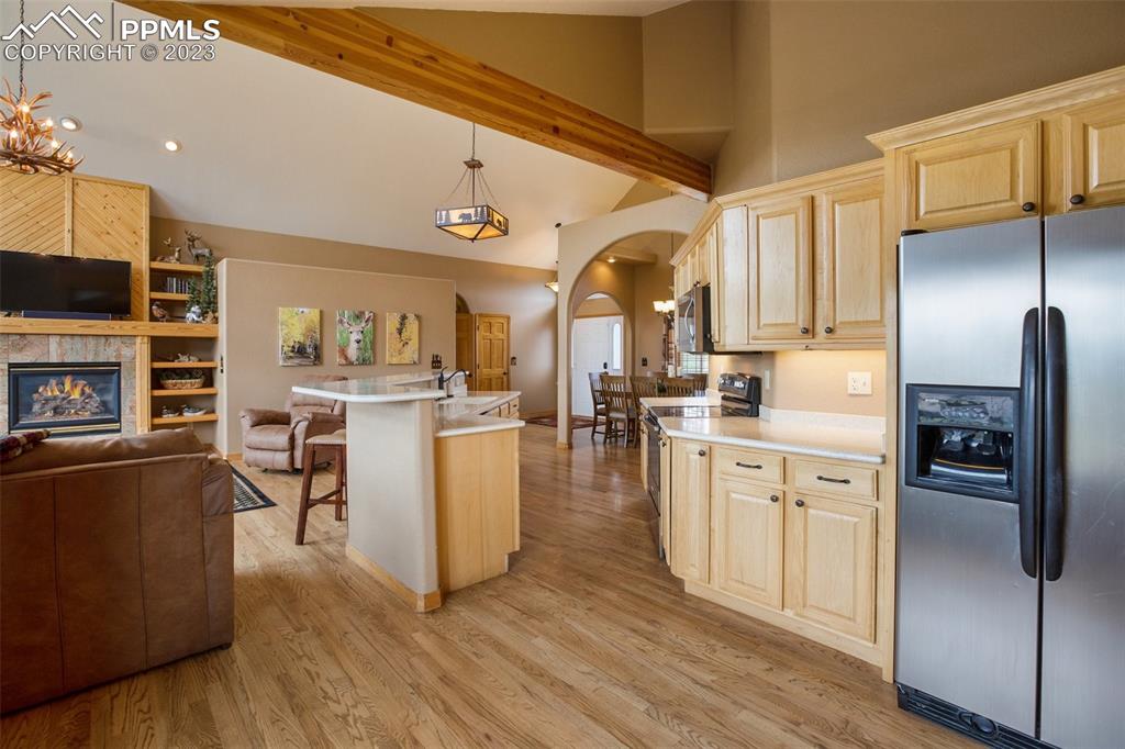 113 Matthew Road Divide, CO 80814 - Photo 11 of 49 a kitchen with stainless steel appliances granite countertop a refrigerator a stove oven and white cabinets with wooden floors