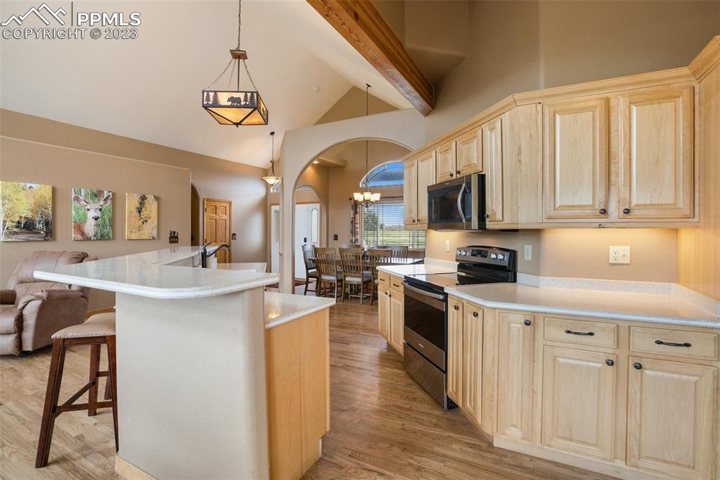113 Matthew Road Divide, CO 80814 - Photo 15 of 49 a kitchen with stainless steel appliances granite countertop a stove top oven a sink dishwasher and white cabinets with wooden floor