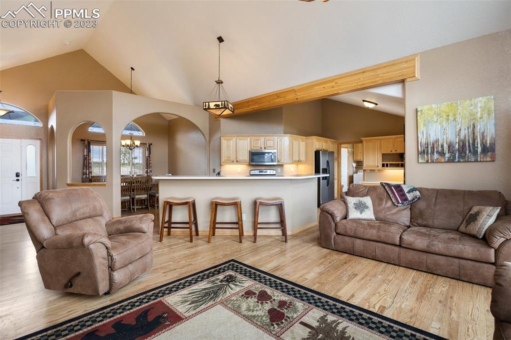 113 Matthew Road Divide, CO 80814 - Photo 7 of 49 a living room with couches and kitchen view with wooden floor