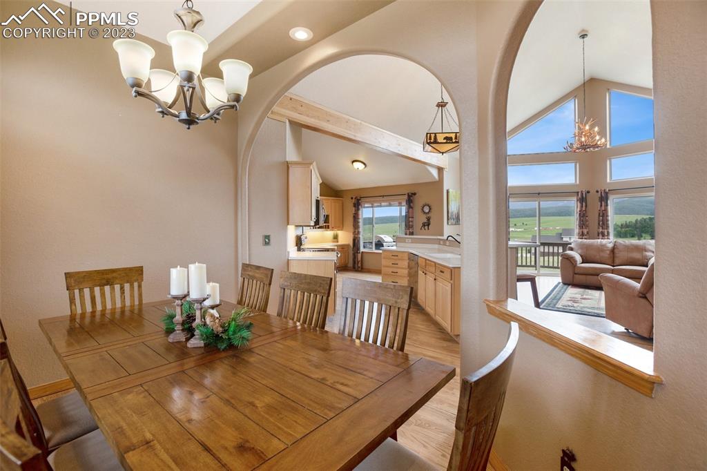 113 Matthew Road Divide, CO 80814 - Photo 8 of 49 a view of a dining room with furniture a chandelier and wooden floor