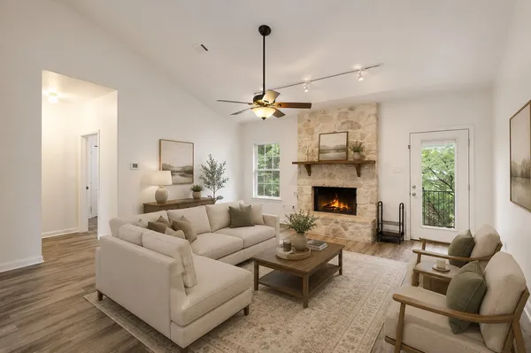 a living room with furniture and a fireplace