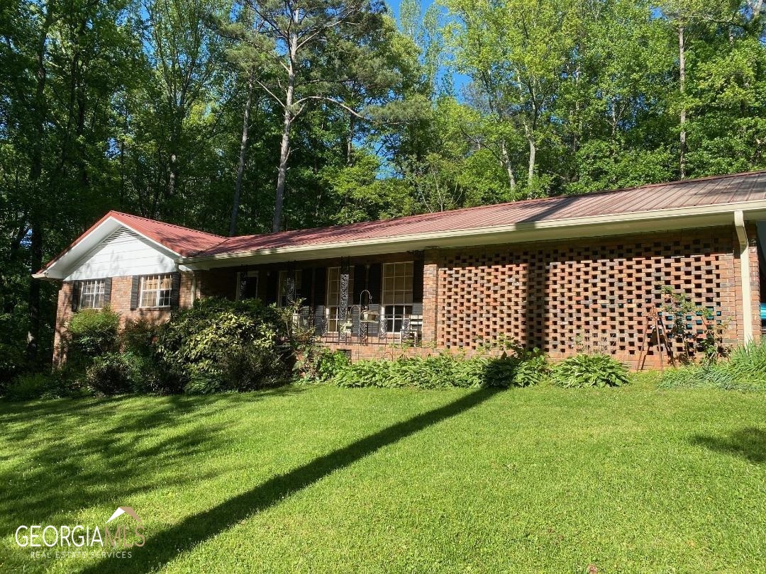 a front view of a house with a garden