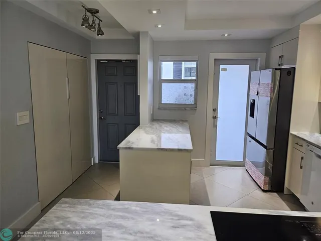 a kitchen with stainless steel appliances a sink stove and cabinets