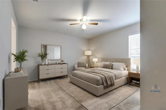 a bedroom with bed and a chandelier