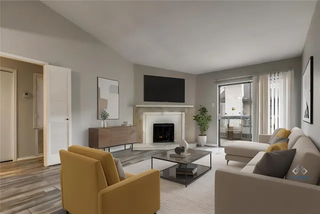 a living room with furniture a fireplace and a flat screen tv