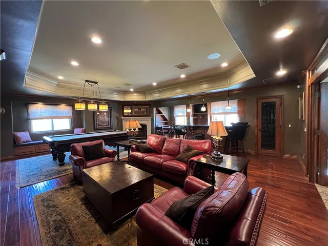 a living room with furniture a wooden floor and window