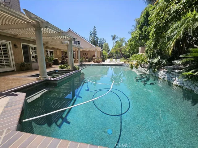 a view of a patio with table and chairs barbeque potted plants and large tree