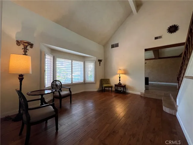 a view of a workspace with furniture and a window