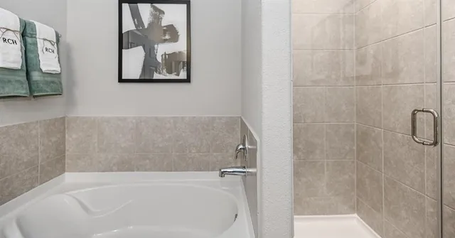 a utility room with wooden floor washer and dryer