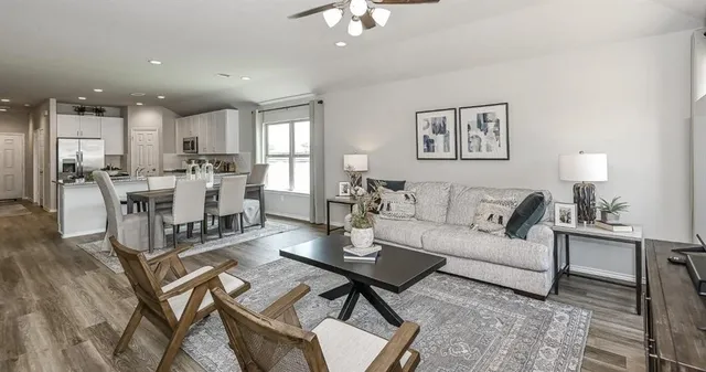 a view of a dining room with furniture a chandelier and wooden floor