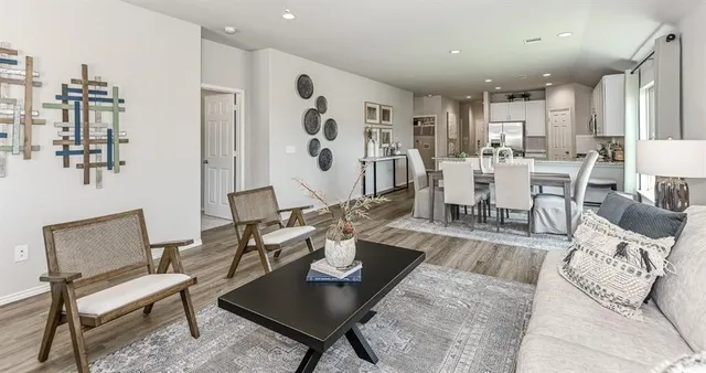 a living room with lots of furniture and view of kitchen