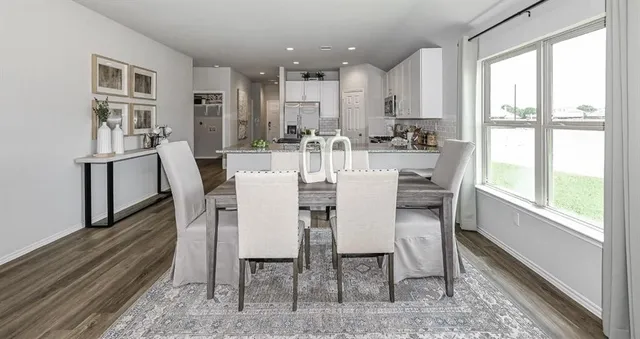 a view of a dining room with furniture window and wooden floor