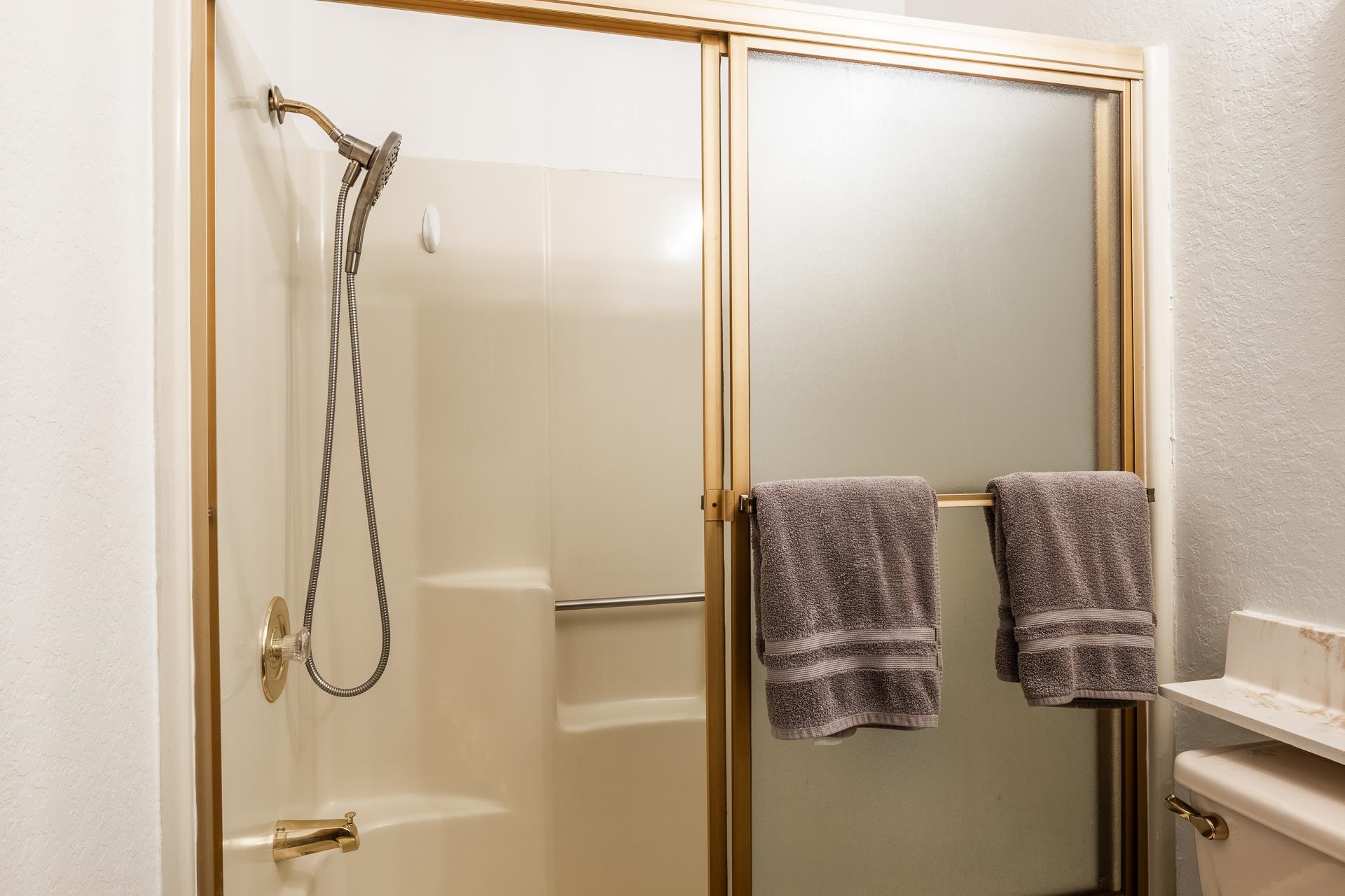 354 Joaquin Road, Unit 4 Mammoth Lakes, CA 93546 - Photo 25 of 40 Bathroom featuring a shower with door and a textured wall