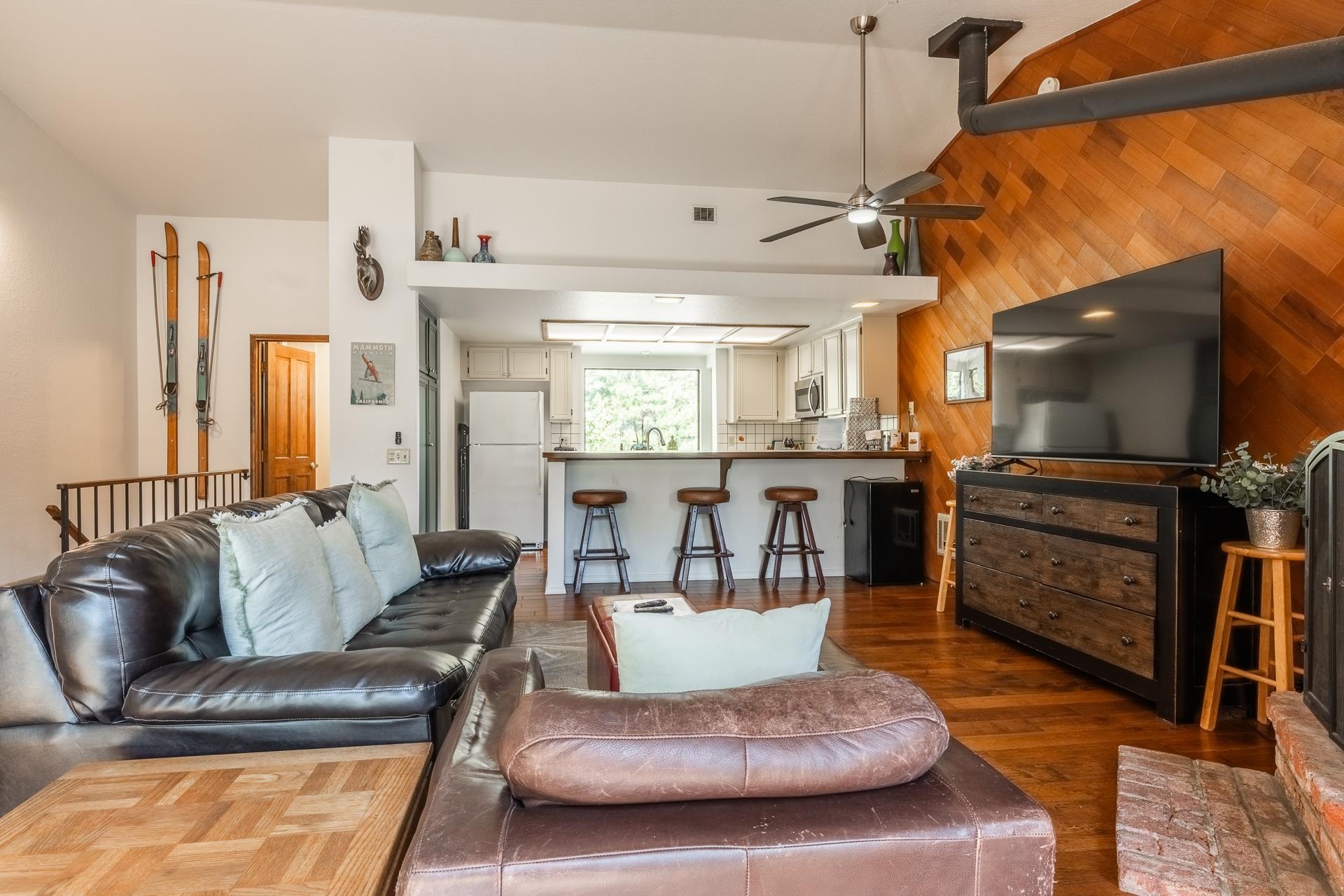 354 Joaquin Road, Unit 4 Mammoth Lakes, CA 93546 - Photo 6 of 40 Living area featuring ceiling fan, wood walls, and dark wood finished floors
