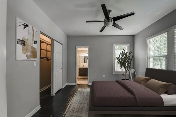 a view of a room with wooden floor a ceiling fan and a window