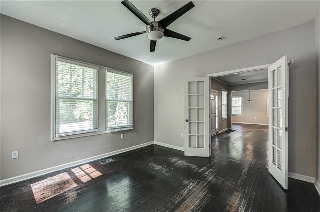 483 Burlington Road Northeast Atlanta, GA 30307 - Photo 13 of 18 a view of empty room with wooden floor and fan