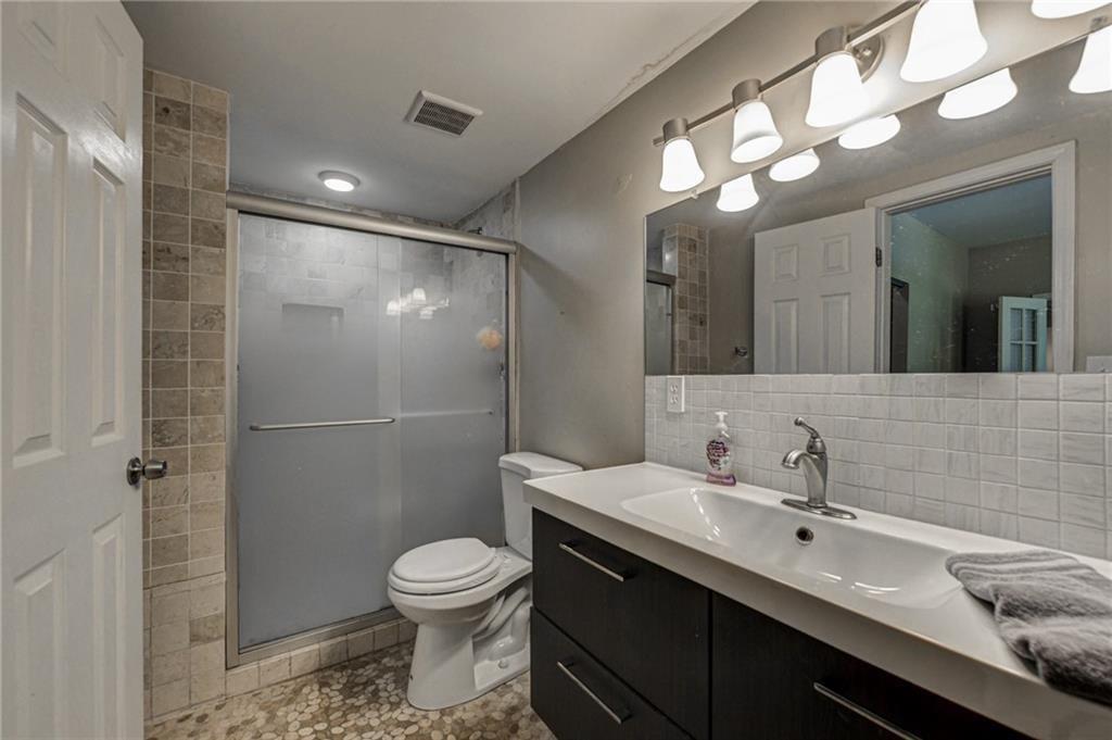 483 Burlington Road Northeast Atlanta, GA 30307 - Photo 15 of 18 a bathroom with a toilet sink and shower