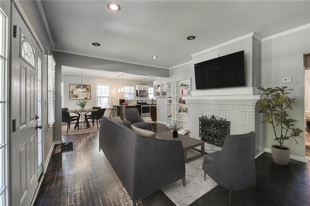 483 Burlington Road Northeast Atlanta, GA 30307 - Photo 3 of 18 a living room with furniture a flat screen tv and a fireplace