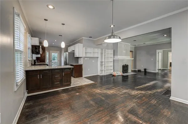 a large kitchen with stainless steel appliances granite countertop a sink stove and cabinets