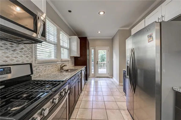a bedroom with a bed and a large mirror with a chandelier