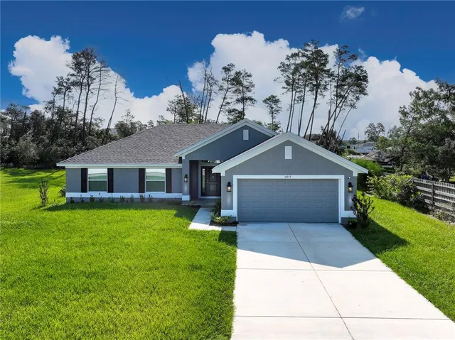 a front view of a house with a yard and garage