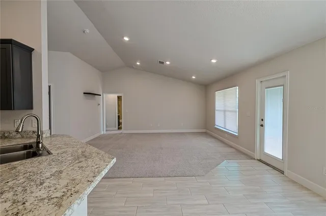 a view of a kitchen with a sink and a window