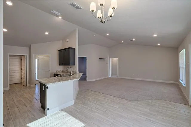 a kitchen with a stove and a wooden floors