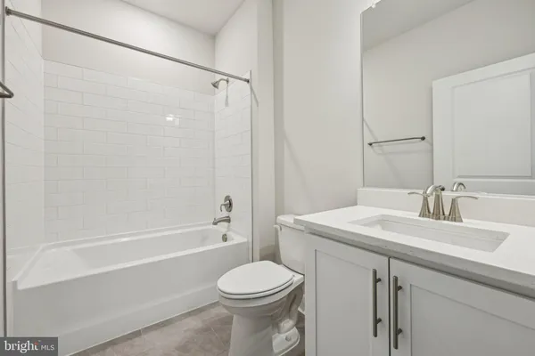 a bathroom with a sink toilet vanity and shower