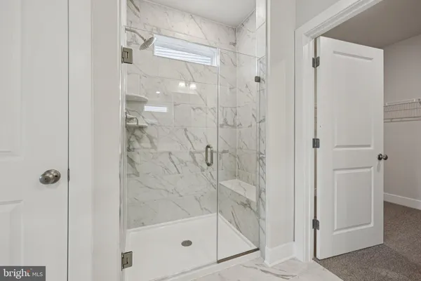a bathroom with a glass shower door