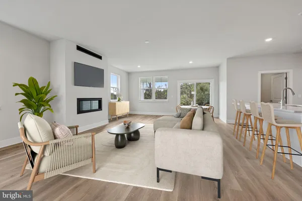 a living room with furniture fireplace and a table