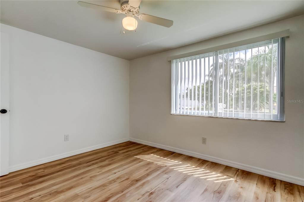 3625 Delta Place Holiday, FL 34691 - Photo 20 of 48 a view of empty room with wooden floor and fan