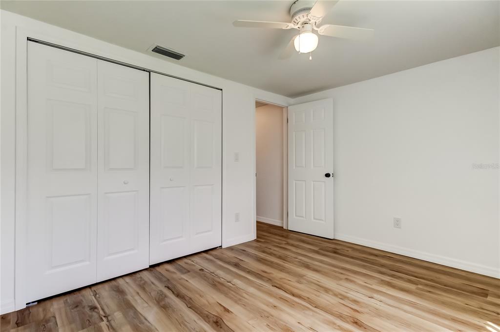 3625 Delta Place Holiday, FL 34691 - Photo 21 of 48 a view of empty room with wooden floor and fan