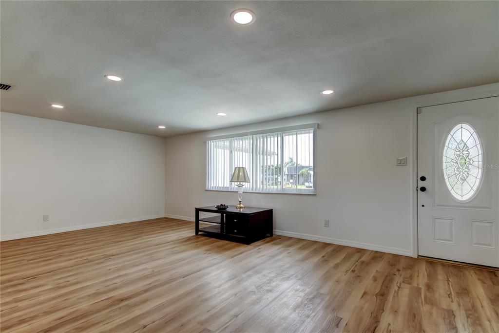3625 Delta Place Holiday, FL 34691 - Photo 23 of 48 an empty room with wooden floor and windows