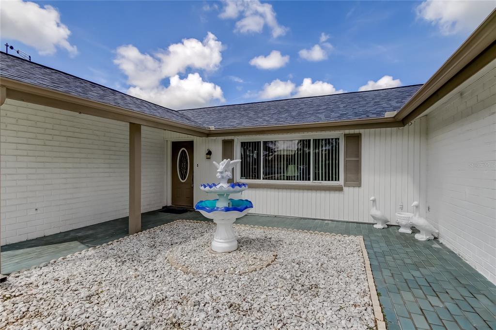 3625 Delta Place Holiday, FL 34691 - Photo 24 of 48 a front view of a house with garden