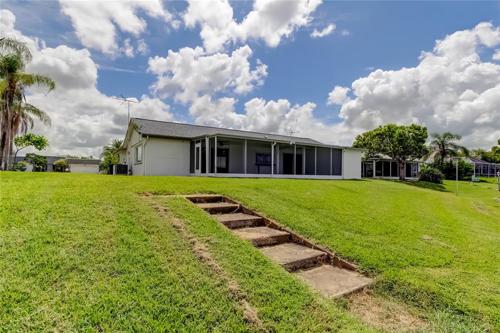3625 Delta Place Holiday, FL 34691 - Photo 29 of 48 a view of a house with a big yard plants and large trees