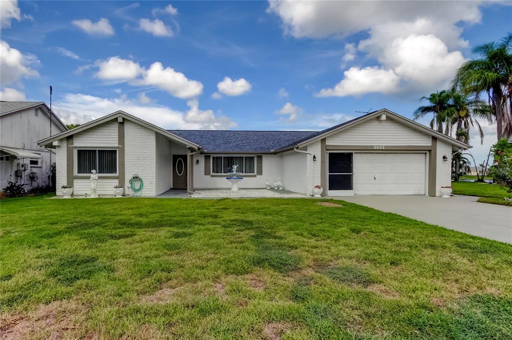 3625 Delta Place Holiday, FL 34691 - Photo 3 of 48 a front view of a house with a garden