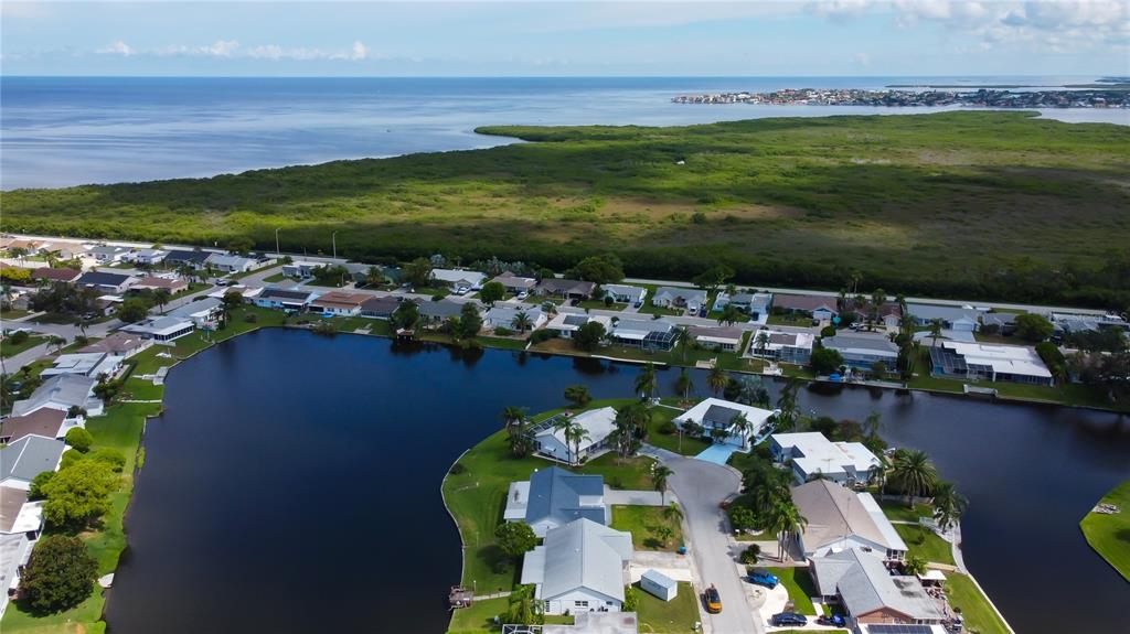 3625 Delta Place Holiday, FL 34691 - Photo 32 of 48 a view of a lake with a houses