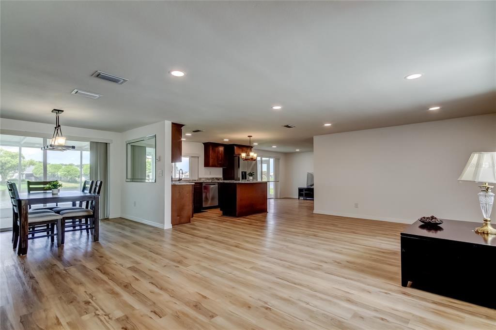 3625 Delta Place Holiday, FL 34691 - Photo 10 of 48 a view of a kitchen with dining room and wooden floor