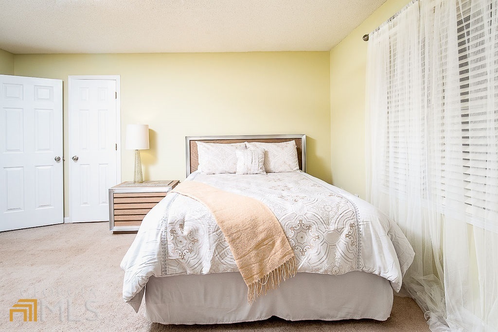 570 Reed Street Southeast Atlanta, GA 30312 - Photo 4 of 11 a bedroom with a bed and a painting on the wall