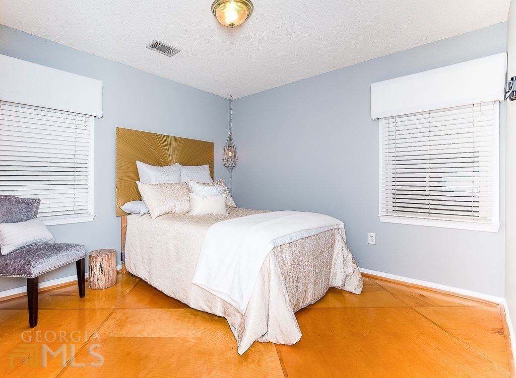 570 Reed Street Southeast Atlanta, GA 30312 - Photo 10 of 11 a bedroom with a bed lamps and window