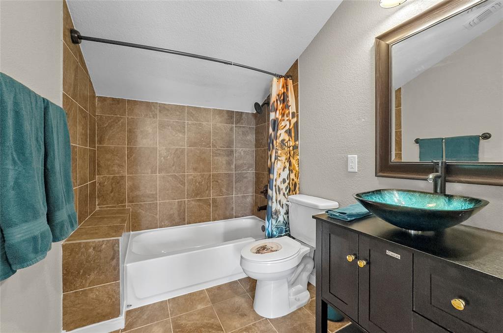 459 Pr Road 2625 Decatur, TX 76234 - Photo 21 of 40 a bathroom with a granite countertop sink a toilet a mirror and bathtub