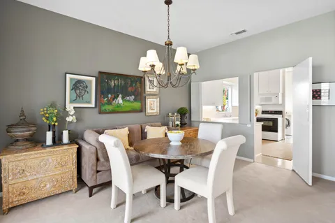a view of a dining room with furniture and chandelier