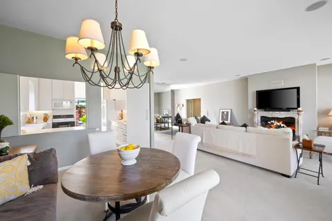 a living room with fireplace furniture and a chandelier