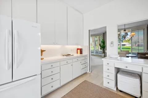 a bedroom with furniture and a large window