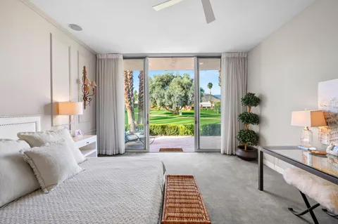 a bed room with a bed and a large window