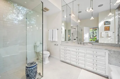 a bathroom with a tub sink and mirror