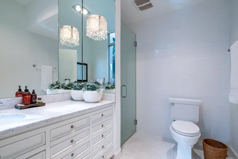 a bathroom with a double vanity sink mirror and double