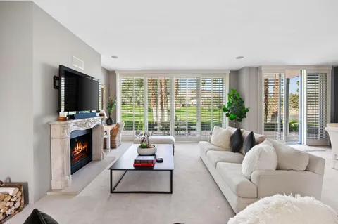 a living room with furniture fireplace and flat screen tv